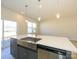 Well-lit kitchen island with stainless steel sink and modern faucet, sleek gray cabinetry, and stainless dishwasher at 8021 Lerwick Trl, Charlotte, NC 28269