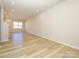 Bright and airy living room with stylish wood-look floors and plenty of natural light at 8021 Lerwick Trl, Charlotte, NC 28269