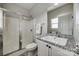 Bathroom featuring granite vanity, neutral walls, framed mirror, and glass shower at 10071 Highland Creek Cir, Indian Land, SC 29707