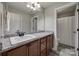 Bathroom vanity features granite counters, white sink and wood cabinets at 10071 Highland Creek Cir, Indian Land, SC 29707