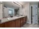 Primary bathroom boasts dual sinks, granite countertop, and walk in closet at 10071 Highland Creek Cir, Indian Land, SC 29707