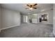 Expansive room with neutral walls, ceiling fan and grey carpet offering a versatile space at 10071 Highland Creek Cir, Indian Land, SC 29707
