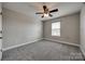 Bedroom featuring a ceiling fan, gray carpet, neutral walls, and window at 10071 Highland Creek Cir, Indian Land, SC 29707