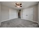 Bedroom features gray carpet, neutral walls, ceiling fan, and double closet doors at 10071 Highland Creek Cir, Indian Land, SC 29707