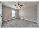 Bedroom featuring a ceiling fan, grey carpet, neutral walls, and window at 10071 Highland Creek Cir, Indian Land, SC 29707