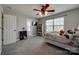 Bedroom with ceiling fan, large window, grey carpet, and closet space at 10071 Highland Creek Cir, Indian Land, SC 29707