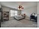 Neutral bedroom with gray carpet, ceiling fan, and large window at 10071 Highland Creek Cir, Indian Land, SC 29707