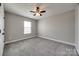 An airy bedroom with neutral walls and carpet at 10071 Highland Creek Cir, Indian Land, SC 29707