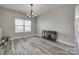 Dining area featuring contemporary chandelier, new floors, and large window with natural light at 10071 Highland Creek Cir, Indian Land, SC 29707