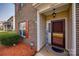 Close-up of the front door with brick facade, shutters and a welcoming 'Hey Friends' sign at 10071 Highland Creek Cir, Indian Land, SC 29707