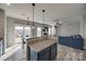 Bright kitchen with stainless steel appliances, granite countertops, and breakfast bar overlooking the living room at 10071 Highland Creek Cir, Indian Land, SC 29707