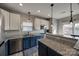 Well-appointed kitchen boasting granite countertops, stainless steel appliances, and stylish blue cabinets at 10071 Highland Creek Cir, Indian Land, SC 29707