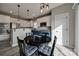 Eat-in kitchen with stainless appliances, granite counters, white and navy cabinets, and modern pendant lighting at 10071 Highland Creek Cir, Indian Land, SC 29707