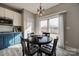 Eat-in kitchen features granite counters, white and navy cabinets, and sliding glass doors to the backyard at 10071 Highland Creek Cir, Indian Land, SC 29707