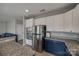 Modern kitchen featuring stainless steel appliances, stylish two-tone cabinets, and granite countertops at 10071 Highland Creek Cir, Indian Land, SC 29707