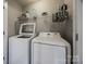 Laundry room with washer, dryer, storage shelf, and ironing board at 10071 Highland Creek Cir, Indian Land, SC 29707