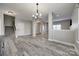 Bright and airy living room with wood flooring, showcasing the open layout and staircase at 10071 Highland Creek Cir, Indian Land, SC 29707
