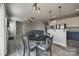 Open-concept living room featuring gray wood floors, a modern chandelier, and easy access to the kitchen at 10071 Highland Creek Cir, Indian Land, SC 29707