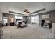 Large main bedroom with tray ceilings, neutral paint, and nice bed and furniture at 10071 Highland Creek Cir, Indian Land, SC 29707
