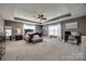 Spacious main bedroom features tray ceiling, ceiling fan, and sitting area at 10071 Highland Creek Cir, Indian Land, SC 29707