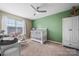 Cozy Bedroom featuring a rocking chair and crib with a neutral color scheme at 102 Brandywine Ne Dr # R3, Conover, NC 28613