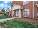 Brick townhome exterior with a covered front entrance, white columns, and well-manicured lawn at 102 Brandywine Ne Dr # R3, Conover, NC 28613