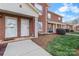 Brick townhome exterior featuring covered front entrances, red shutters, and manicured landscaping at 102 Brandywine Ne Dr # R3, Conover, NC 28613