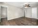 Bright bedroom with dark wood floors, ceiling fan, and ensuite bathroom access at 1024 Eaglewood Ave, Charlotte, NC 28212