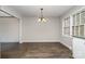 Bright, airy dining room with a chandelier, a large window, and wood-look flooring at 1024 Eaglewood Ave, Charlotte, NC 28212