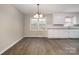 Cozy dining area with a classic chandelier, bright window and direct access to kitchen at 1024 Eaglewood Ave, Charlotte, NC 28212