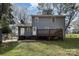 View of the back exterior with a deck and well-maintained lawn at 1024 Eaglewood Ave, Charlotte, NC 28212