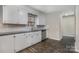 Bright kitchen with white cabinets, stainless steel appliances, subway tile backsplash, and granite countertops at 1024 Eaglewood Ave, Charlotte, NC 28212