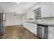 Bright kitchen featuring granite counters, stainless dishwasher, and a view into the dining area at 1024 Eaglewood Ave, Charlotte, NC 28212