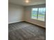 This bedroom features neutral walls, cozy carpet and a window with a view of the neighborhood at 103 High Rock Ct # 11, Statesville, NC 28677