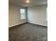 Comfortable bedroom with two bright windows, soft carpet, and neutral walls at 103 High Rock Ct # 11, Statesville, NC 28677