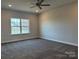 Bright bedroom with a ceiling fan and a large window at 103 High Rock Ct # 11, Statesville, NC 28677