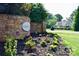 Beautiful stone entrance sign with colorful flower bed and a glimpse of a house at 103 High Rock Ct # 11, Statesville, NC 28677