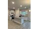 This kitchen features stainless steel appliances, a large island, white cabinets, and granite countertops at 103 High Rock Ct # 11, Statesville, NC 28677