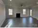 Bright living room featuring modern floors, a cozy fireplace, and ample natural light at 103 High Rock Ct # 11, Statesville, NC 28677