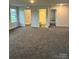 Bright living room with open floor plan, neutral carpeting, and multiple rooms at 103 High Rock Ct # 11, Statesville, NC 28677