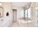 Bright bathroom featuring a large soaking tub with tiled surround and glass shower door at 1100 Millbank Dr, Matthews, NC 28104