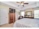 Comfortable bedroom with tray ceilings, natural light, four poster bed, and a TV at 1100 Millbank Dr, Matthews, NC 28104