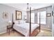 Bedroom featuring a four-poster bed, chandelier, and multiple windows for ample light at 1100 Millbank Dr, Matthews, NC 28104