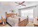 Bedroom featuring wooden bed frame, ceiling fan, and natural light from the window at 1100 Millbank Dr, Matthews, NC 28104