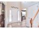 Bright foyer with high ceilings, white wainscoting, and elegant wood-look flooring at 1100 Millbank Dr, Matthews, NC 28104