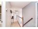 Hallway with carpet, wooden railing, gray paint, and natural light at 1100 Millbank Dr, Matthews, NC 28104