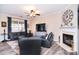 Comfortable living room featuring a fireplace, large TV, and plush black leather seating at 1100 Millbank Dr, Matthews, NC 28104