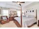 Comfortable bedroom with tray ceilings, natural light, four poster bed, and cozy seating at 1100 Millbank Dr, Matthews, NC 28104