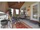 Relaxing screened porch with outdoor seating and a decorative rug at 1100 Millbank Dr, Matthews, NC 28104