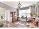 Bright and airy sitting room featuring wood-look flooring, large windows, and neutral decor at 1100 Millbank Dr, Matthews, NC 28104